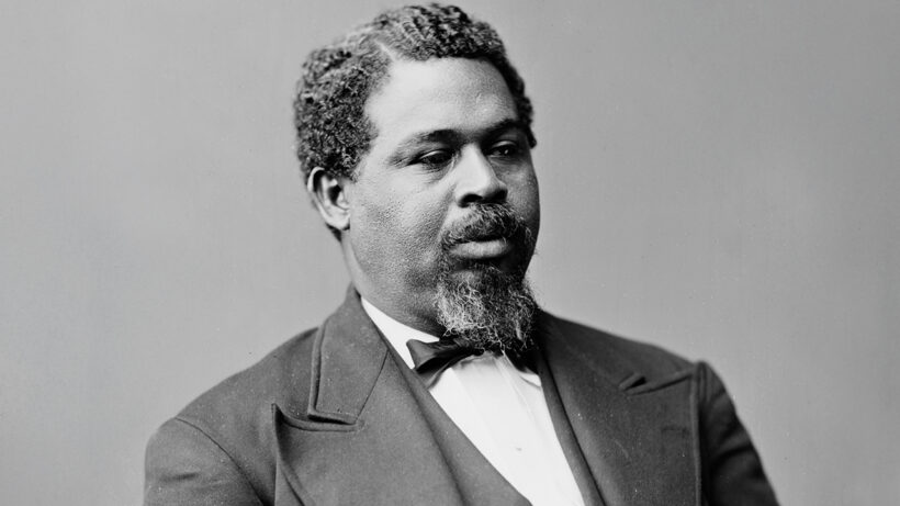 Portrait of Robert Smalls, Civil War hero and African-American leader, wearing a suit and seated, exemplifying dignity and determination.